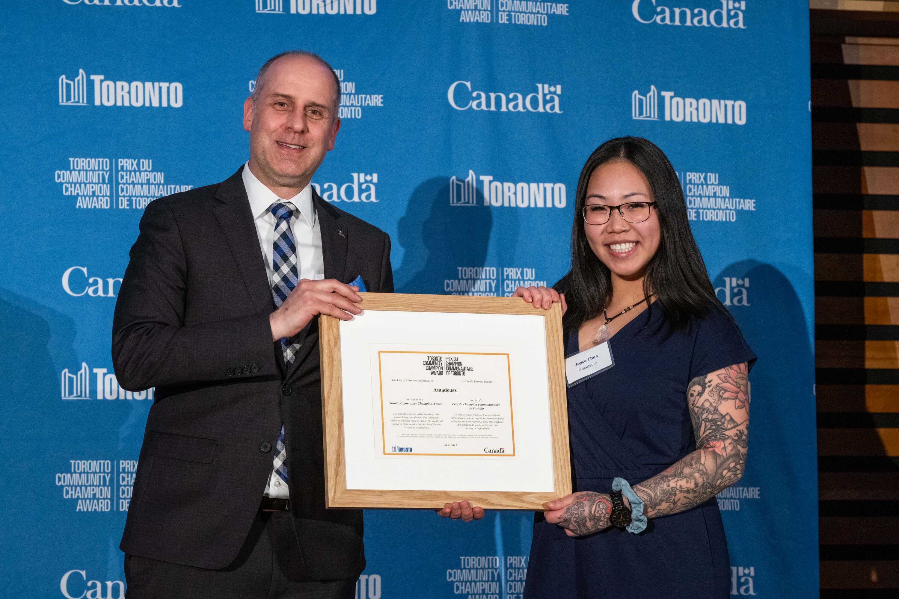 Amadeusz receiving the Toronto Community Champion award, presented by Councillor Stephen Holyday